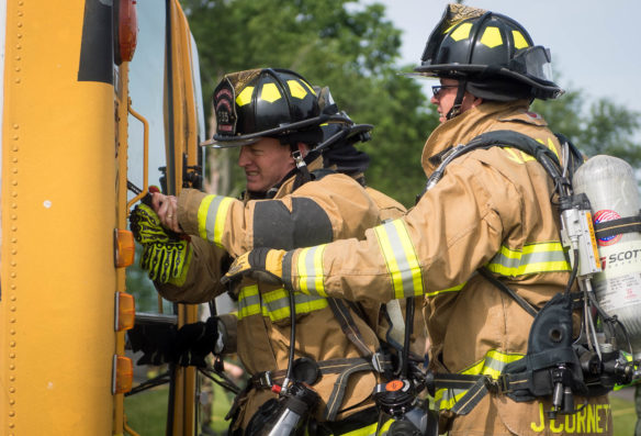Woodford County firefighters use knives to cut out the windshield of a tipped school bus during a mass casualty simulation at the Bluegrass Railroad and Museum.<br srcset=