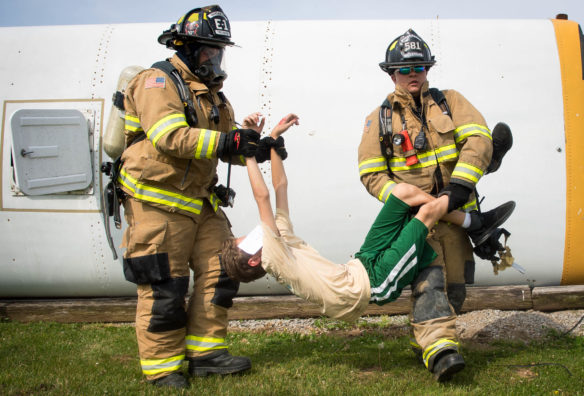 Woodford County firefighters carry a volunteer acting as a victim during a mass casualty simulation.<br srcset=