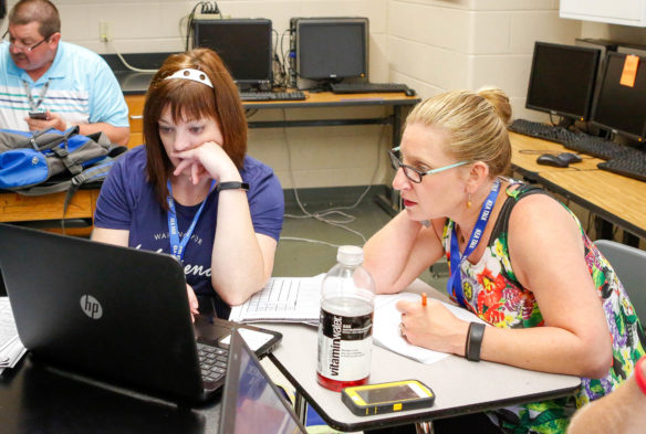 Katie Gibbons (left) and Elizabeth King, teachers at R.C. Hindsdale Elementary (Kenton County), examine their school's responses to the TELL survey. The teachers, who are also on the elementary's school-based decision making council, were looking for areas where the school can improve. Photo by Brenna Kelly, June 13, 2017.