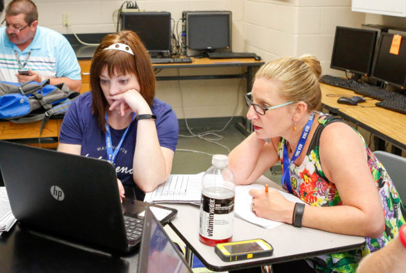 Katie Gibbons (left) and Elizabeth King, teachers at R.C. Hindsdale Elementary (Kenton County), examine their school's responses to the TELL survey. The teachers, who are also on the elementary's school-based decision making council, were looking for areas where the school can improve. Photo by Brenna Kelly, June 13, 2017.