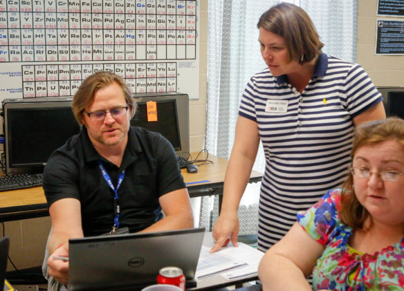 Scott King, a 7th-grade science teacher at Camp Ernst Middle School (Boone County), analyzed his school's TELL survey results with Michelle New, Kentucky Education Association director of professional excellence, at KEA's TALK conference. Teachers delved into their school’s data to find areas for celebration and opportunities for improvement. Photo by Brenna Kelly, June 13, 2017. 