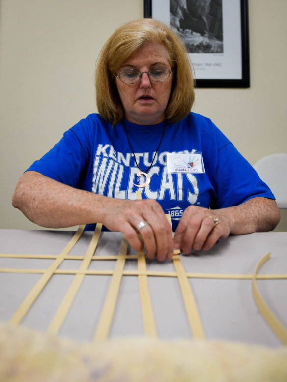 Joanie Cattrell, an art teacher at Radcliff Elementary weaves a basket during the wood base basket for public and educators during the Berea Festival of Learnshops. Photo by Bobby Ellis, July 11, 2017