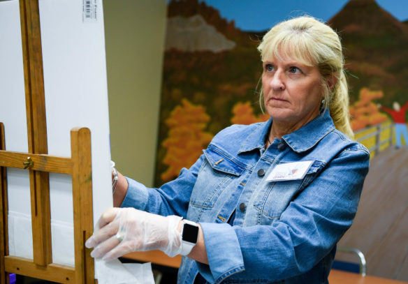 Dianna Williams, an art teacher at Nelson County High School, looks at a picture for reference during the landscape pastels in a day class during the Berea Festival of Learnshops. Williams said that she had attended the workshops four years in a row for her professional development credit. Photo by Bobby Ellis, July 11, 2017