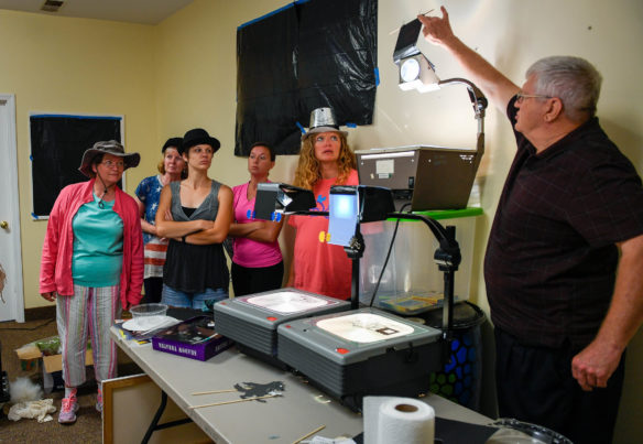 Richard Brown demonstrates how to use projectors during a "shadow puppets for beginners" class at the Berea Festival of Learnshops. Photo by Bobby Ellis, July 11, 2017