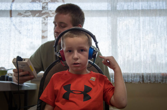 Garrett Runner, a student at Old Mill Elementary (Bullitt County) takes a hearing test during the Bullitt County Kindergarten Kickoff.  Photo by Bobby Ellis, July 25, 2017