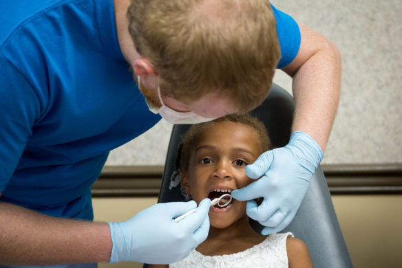 Elise Johnson, a kindergartner at Lebanon Johnson Elementary (Bullitt County) has her teeth checked at the Bullitt County Kindergarten Kickoff. Photo by Bobby Ellis, July 25, 2017