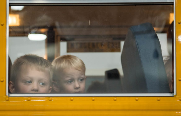 Jaxson Corbitt, left, a kindergartner at Crossroads Elementary, and his younger brother, Keegan Corbitt, look out of a bus brought to the Bullitt County Kindergarten Kickoff for first time students to see what it's like to get on a bus.  Photo by Bobby Ellis, July 25, 2017