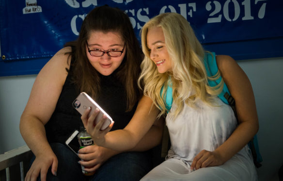 Mikala LInney, left, and Brianna Hollon take a selfie on the first day back to school at Frankfort High School (Frankfort Indepenedent).  Photo by Bobby Ellis, Aug. 1, 2017