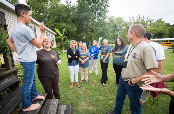 Miles Frailey, a student at Webster County Middle School, greets a group of teachers as they visit his home during the Webster County Schools opening day kickoff.  Photo by Bobby Ellis, Aug. 7, 2017