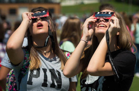 Vada Coffee, left, and Cameron Foster, freshmen at Allen County-Scottsville High School, look through special solar eclipse viewers as the moon passes in front of the sun. The staff at Allen County's schools stressed safety while students were viewing the eclipse. Photo by Bobby Ellis, Aug. 21, 2017