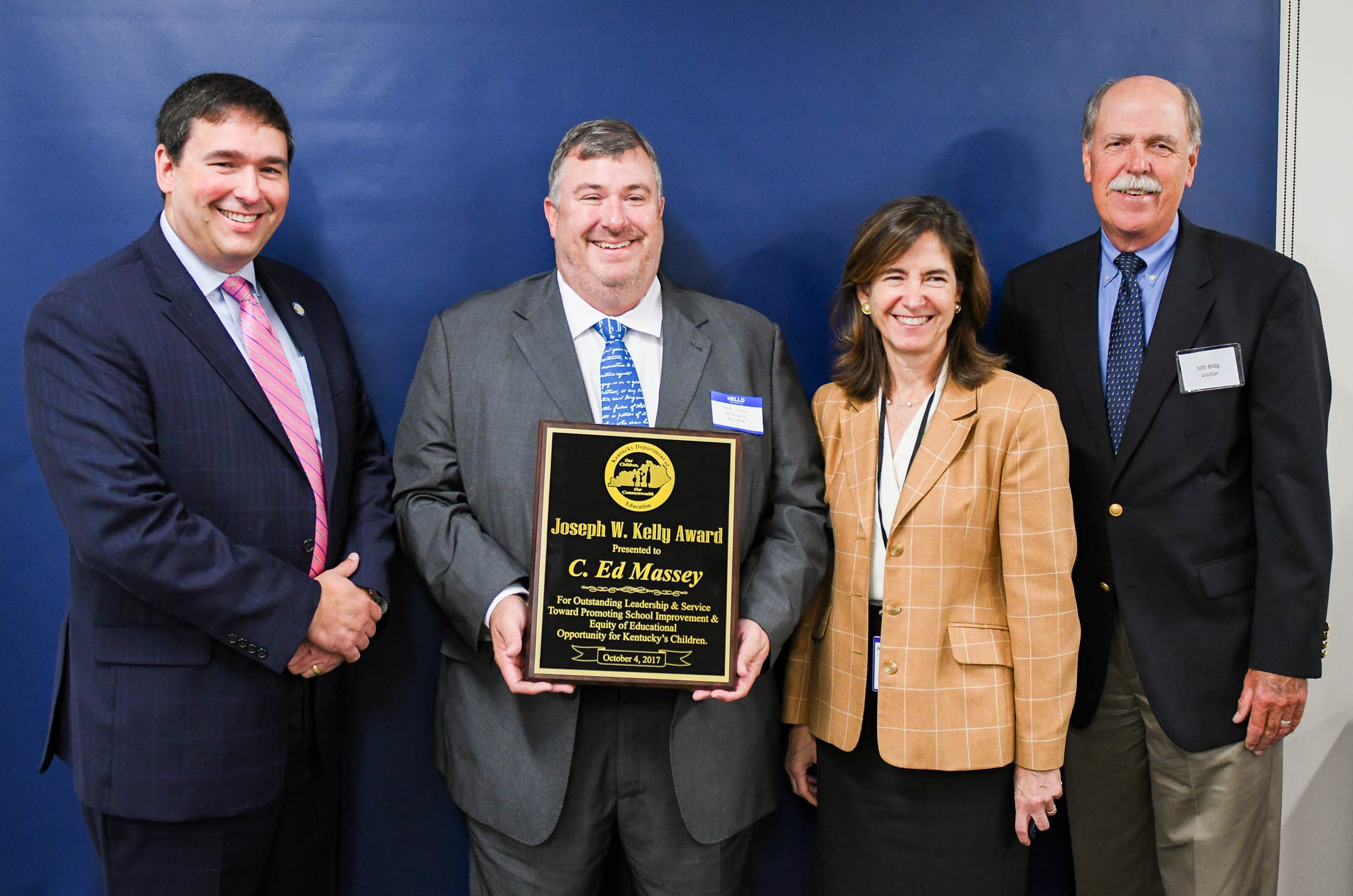 Kentucky Board of Education Chair Mary Gwen Wheeler, accompanied by Commissioner Stephen Pruitt (far left), presents the Joseph W. Kelly Award to northern Kentucky attorney C. Ed Massey (holding plaque), a long time Kenton Co. Board of Education member. The award, named for former KBE chair and businessman Joe Kelly (far right), is given to businesspeople who offer outstanding leadership and service toward promoting school improvement and equitable educational opportunities for all Kentucky children. Photo by Bobby Ellis, Oct. 4, 2017