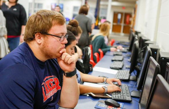 Students complete college applications online during a college application day at Russell County High School. The 22 districts served by college and career counselors hired through a federal grant saw their college and career readiness scores increase at a pace well above the statewide average during the life of the grant. Photo by Mike Marsee, Sept. 29, 2017