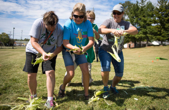 Kentucky School for the Deaf staff members compete in a corn shucking contest. Photo by Bobby Ellis, Oct. 6, 2017