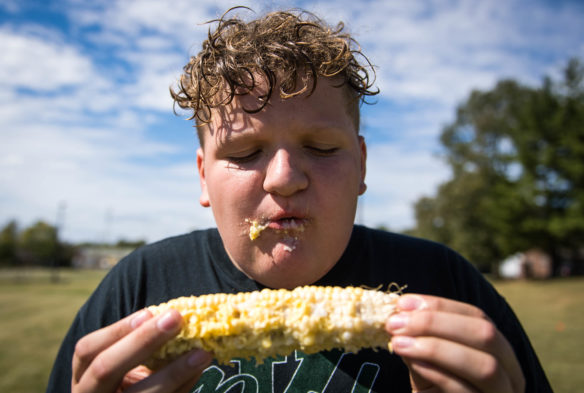 James David, a 12th-grader at KSD, competes in the corn eating contest at the Sweet Corn Festival. Photo by Bobby Ellis, Oct. 6, 2017