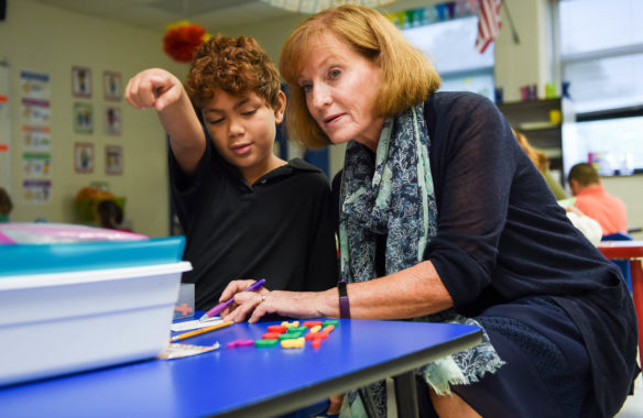 Literacy Coach Debbie Baker works with Desmond Hernandez, a 2nd-grader at Simmons Elementary, on building words with magnetic letters. The school uses the letters, white boards and sound boxes to help students build literacy skills. Photo by Bobby Ellis, Oct. 9, 2017