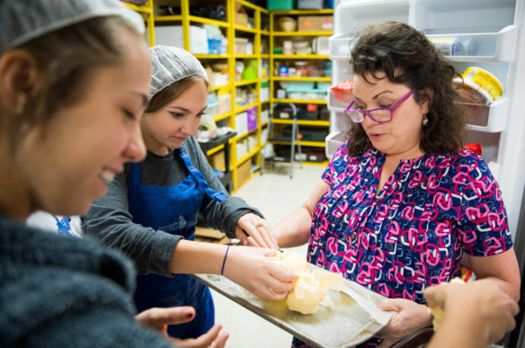 Sarah Raikes, a family and consumer sciences teacher at Washington County High School, gives ice cream balls to students as they prepare make fried ice cream in one of her classes. Raikes was named the 2017 Teacher of the Year by the Association for Career and Technical Education. Photo by Bobby Ellis, Oct. 17, 2017