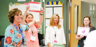 LaTonya Taylor-Rowe, a 1st-grade teacher at Highland Elementary School (Johnson County), points to fellow teachers who are demonstrating one of the songs she uses to help her students better understand mathematics standards during the Let’s TALK: Conversations About Effective Teaching and Learning conference in Lexington. Photo by Mike Marsee, June 12, 2017