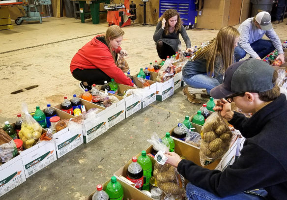 Clark County FFA members sort and box nonperishable food items collected during the organization’s annual food drive. Altogether 100 families received food baskets for the Thanksgiving holiday. Submitted photo by Terra Pigg