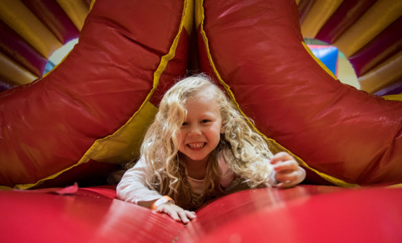 Nevaeh Likes, a preschooler at Northside Elementary, crawls through a bounce house at the Northside Fall Festival. Photo by Bobby Ellis, Oct. 27, 2017