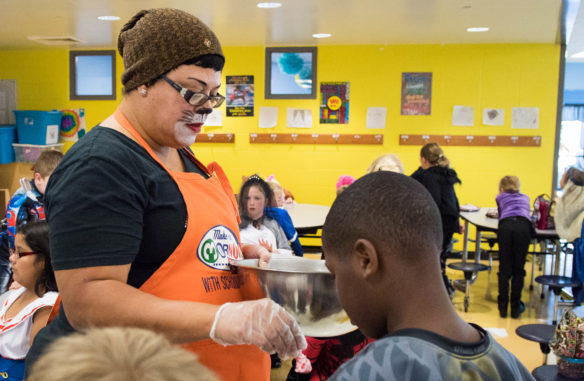 Sherry Jackson hands out candy to students during lunch at Huntertown Elementary (Woodford County). Photo by Bobby Ellis, Oct. 31, 2017