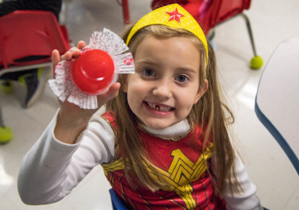 Skylar Greenup-Jones, a kindergartner at Huntertown Elementary (Woodford County) shows off her "monster slime" while dressed as Wonder Woman. Photo by Bobby Ellis, Oct. 31, 2017