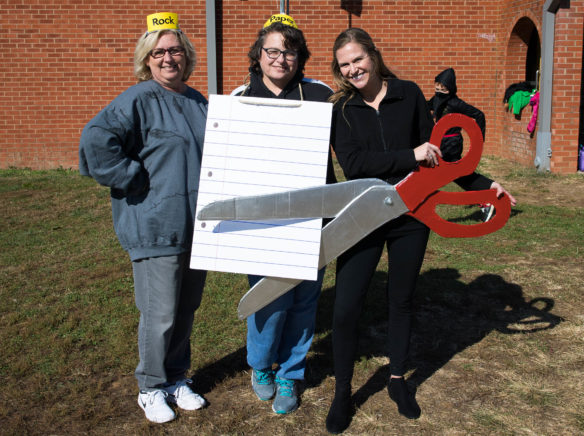 Third-grade teachers Betty English, left, Wendy Birch and Amanda Nugent pose as "Rock-Paper-Scissors." Photo by Bobby Ellis, Oct. 31, 2017