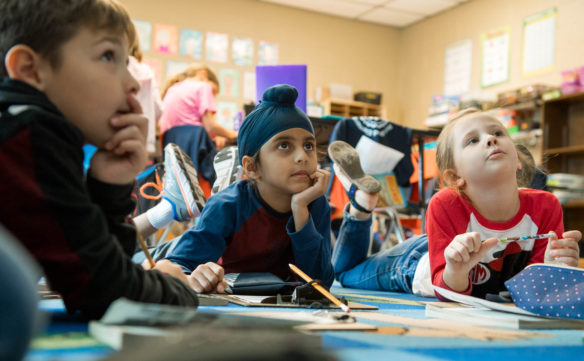 Navnit Singh, middle, a 1st-grader at Rich Pond Elementary (Warren County), listens to Sarah Miller during a reading comprehension exercise. Photo by Bobby Ellis, Dec. 4, 2017
