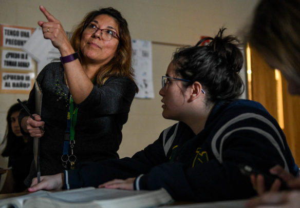 Laura DeVettori, left, a teacher in the Spanish immersion program at Bryan Station High School (Fayette County), talks with student Maria Vela about a piece of literature tied to the painting "Saturn Devouring His Son" in her Spanish immersion AP literature course. Students at Fayette County schools who become proficient in at least two languages are eligible to earn the Seal of Biliteracy from the district. Photo by Bobby Ellis, Dec. 7, 2017