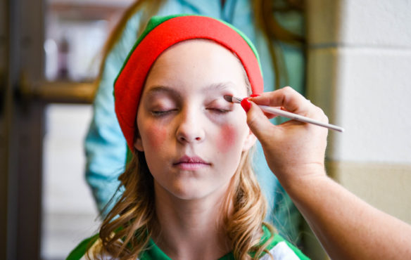 Peyton Ramsey, a 7th-grader at Lincoln County Middle School, gets her makeup touched up by Stacey Clark before warm-ups for the morning performance of Elf, Jr. the Musical. Carlee Cornett's group of middle school actors perform for kindergarten and middle school students before opening the play up to the public. Photo by Bobby Ellis, Dec. 8, 2017