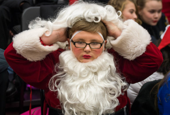 Seth Reynolds, an 8th-grader at Lincoln County Middle School, puts on his Santa wig backstage. Photo by Bobby Ellis, Dec. 8, 2017