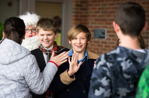 Jackson Sims, a 7th-grader at Lincoln County Middle School, left, and Trevor Bennett, a 7th-grader at Lincoln County Middle School, get high fives from teachers and classmates after performing Elf, Jr. the Musical. Photo by Bobby Ellis, Dec. 8, 2017