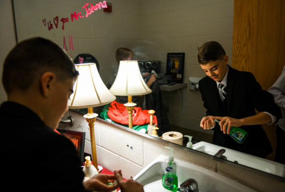 Sam Singleton, an 8th-grader at Lincoln County Middle School, washes up after the morning performance of Elf, Jr. the Musical. Photo by Bobby Ellis, Dec. 8, 2017