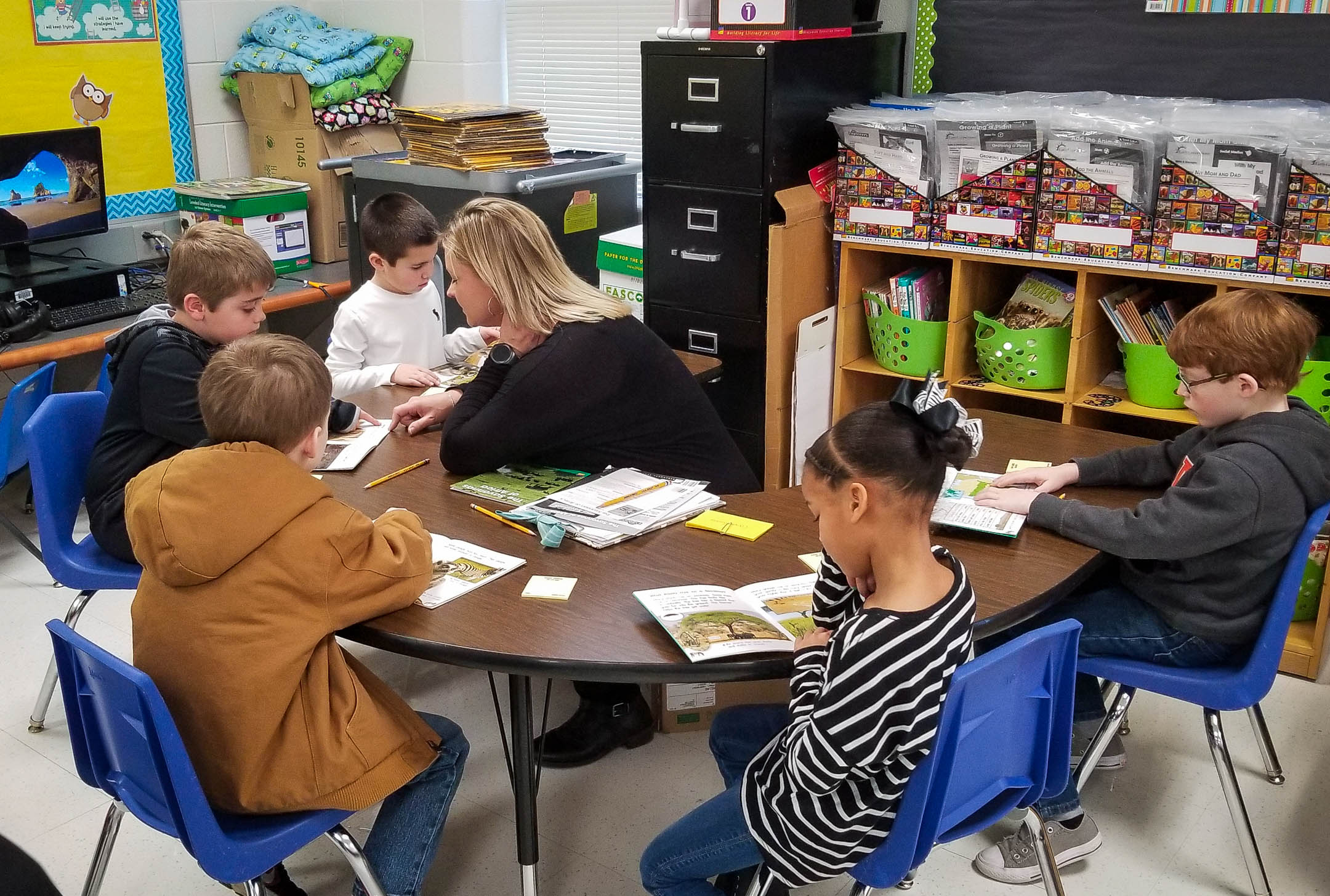 Kara Stevenson delivers instruction during a guided reading lesson. Students are whisper reading independently as Stevenson listens to one student read. Pictured from left are Pembroke Elementary School 1st-graders Garrison Meacham, Anniston Meriwether, John Michael Arivn, Camden McGehee and Aiden Riley. Submitted picture by Jennifer Meacham