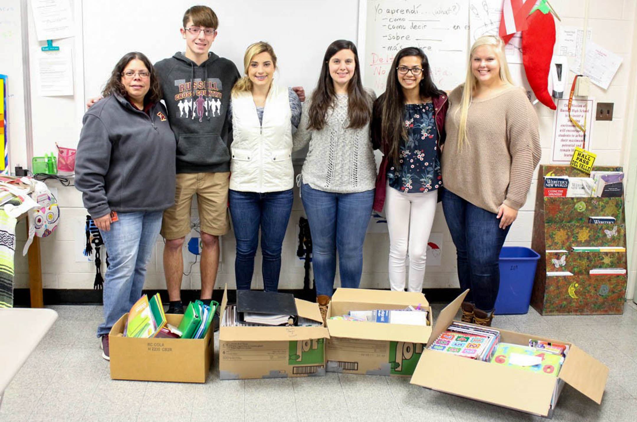 Russell High School Sociedad Honoraria Hispánica students and Spanish teacher Catherine Del Valle, left, show some of the school supplies they collected to help two high schools and one elementary school in Puerto Rico that were hit by Hurricane Maria in September. Submitted photo by Catherine Del Valle