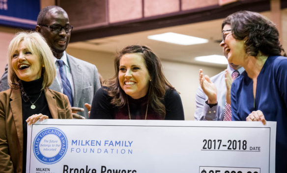 Brooke Powers reacts as she is presented with a $25,000 check from the Milken Family Foundation by prior Milken award winners. Powers said she will probably use some of the money to do "something special" with her two children. Photo by Bobby Ellis, Jan. 9, 2018