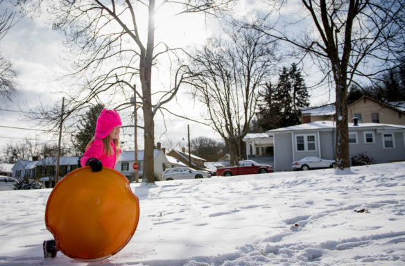 Ella Simpson walks back up a hill with her sled near her house. Photo by Bobby Ellis, Jan. 13, 2018