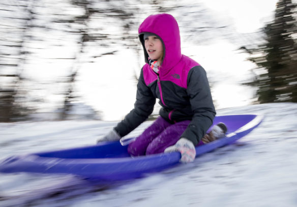 Mia Kinnett, a 6th-grader at Second Street Elementary (Frankfort Independent) rides a sled down a hill in Frankfort. Photo by Bobby Ellis, Jan. 13, 2018