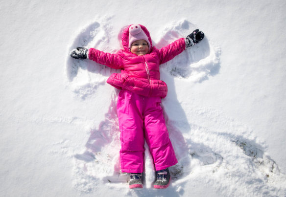 Stella Young, a 3-year-old, makes a snow angel in front of the Capitol in Frankfort. Photo by Bobby Ellis, Jan. 13, 2018