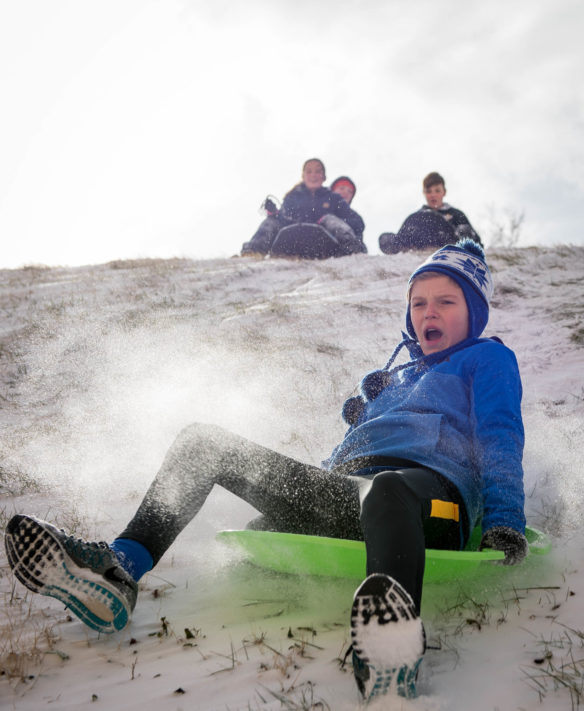 McLain Barber, an 8th-grader at Second Street School (Frankfort Independent), sleds down a hill at the Capitol. Photo by Bobby Ellis, Jan. 13, 2017