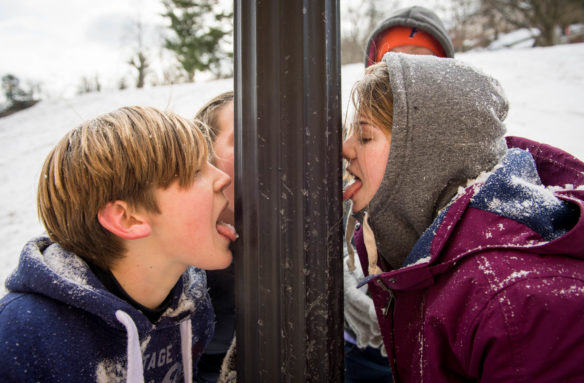 Dawson Pearl, left, and Nevaeh Henderson, an 8th-grader at Second Street School (Frankfort Independent) try to get their tongues to stick to a pole. Photo by Bobby Ellis, Jan. 13, 2018