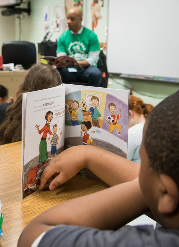 Students in Sarah Blades' 4th-grade class listen to Frank Mabson read a book about a young girl wanting to be president as part of the R.E.A.L. Men Read program. Photo by Bobby Ellis, Jan. 24, 2018