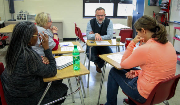 Jim Detwiler, Boone County deputy superintendent, plays Education Ling Bingo, with parents Kathy Smiley, Meg Crail and Kim Webb. Photo by Brenna R. Kelly, Jan. 27, 2018