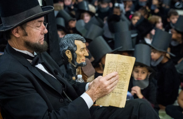 Larry Elliott looks over his speech before students and staff attempt to break the record for the most people dressed as Abraham Lincoln in the same place. Photo by Bobby Ellis, Feb. 14, 2018