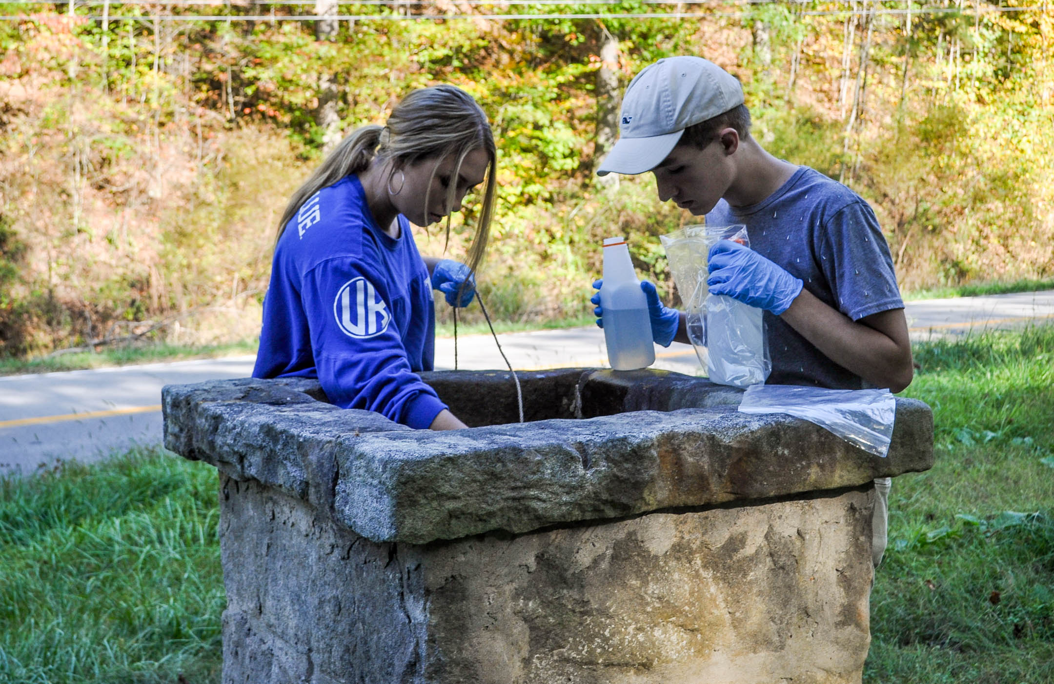 Belfry High School (Pike County) students Aryn Adkins and Austin Dillon collect water from a well in Pike County. Adkins and Dillon are two of the four students that will be traveling to India later this year to present their findings about groundwater quality as part of the U.S. Department of State's Mission to India program. Submitted picture by Carlie McCoy