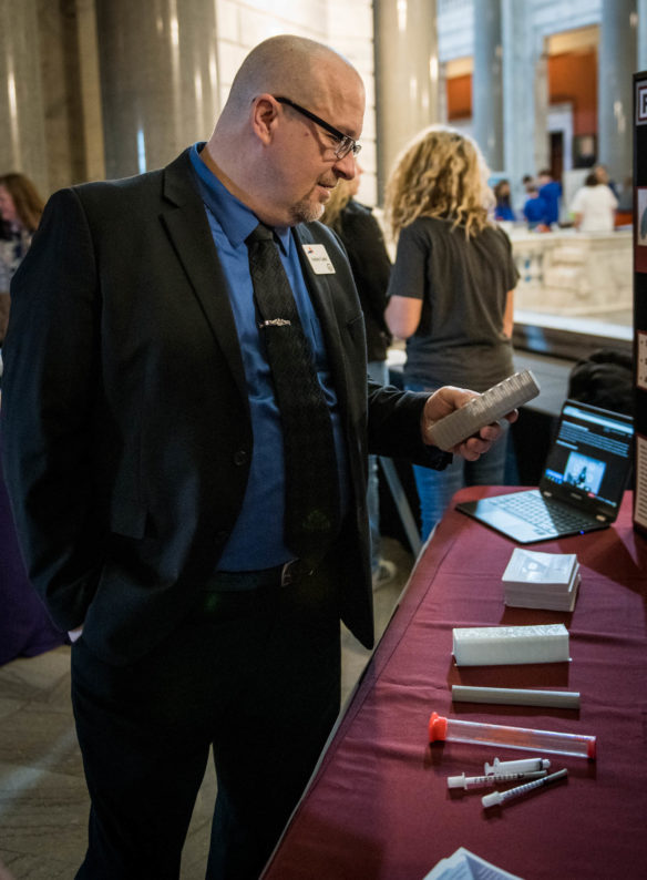 Andrew Castle, of KVEC, looks at the 3D printed plastic device created by students at Ashland Middle School (Ashland Independent) for their Samsung Solve for Tomorrow project. PHoto by Bobby Ellis, March 6, 2018