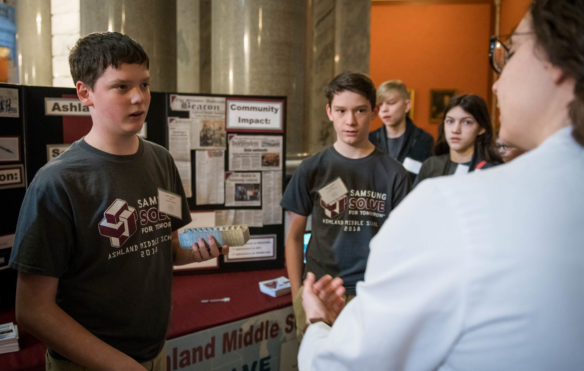 Caleb Campbell, left, and Isaac Campbell, 8th graders at Ashland Middle School, talk to Virginia Fergeson. Photo by Bobby Ellis, March 6, 2018