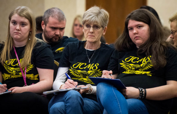 Pam Burton, middle, the coach of the Johnson County Middle School academic team, takes notes during the team's quick recall match against Meyzeek Middle School (Jefferson County) at the Governor's Cup state finals. Burton, a language arts and math teacher, has coached the team for 24 years. Photo by Bobby Ellis, March 19, 2018