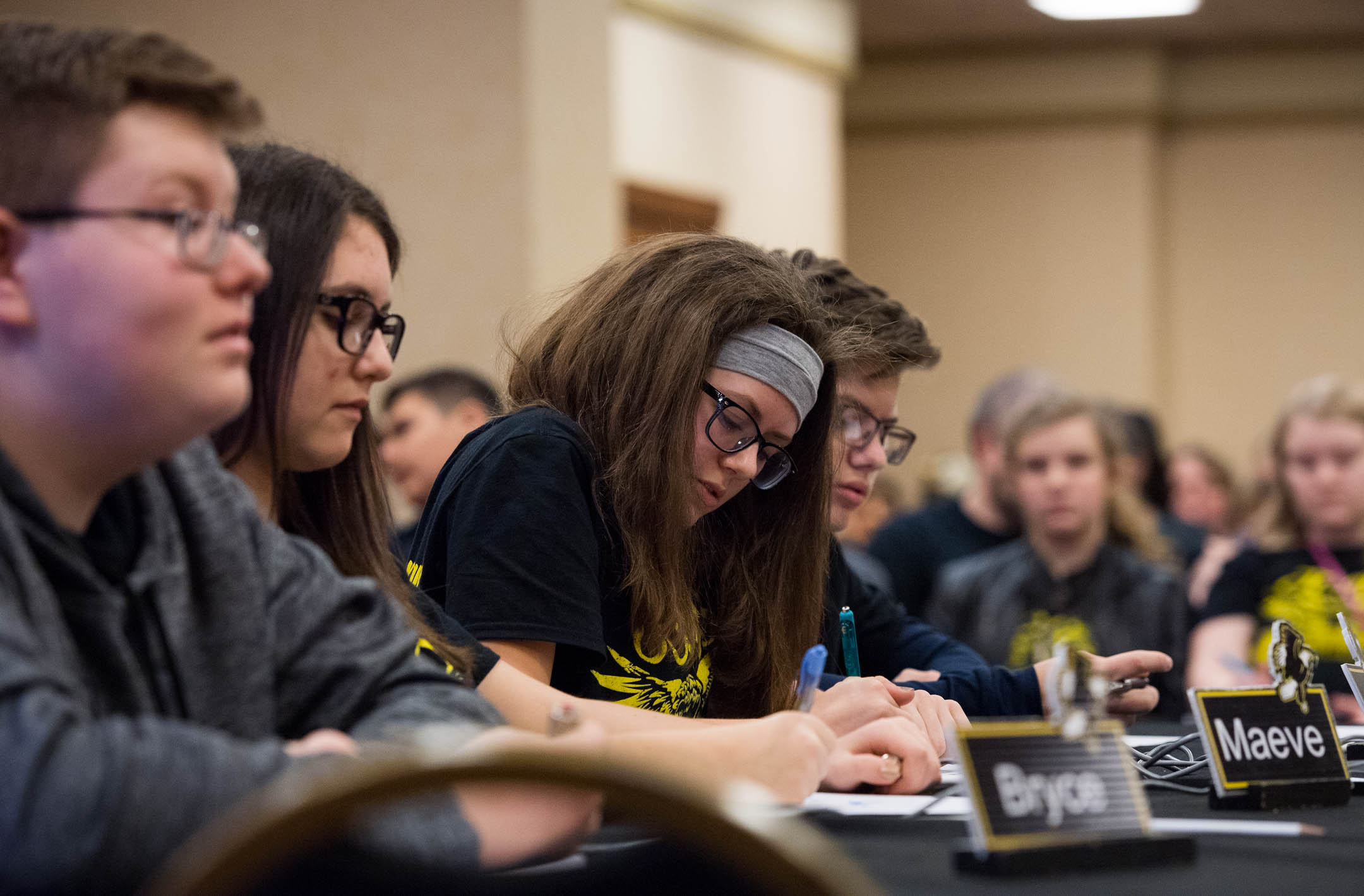 Zoe Castle, an 8th-grader at Johnson County Middle School and academic team captain, writes down a math problem during a quick recall match. The school's academic team has won the Governor's Cup 15 times. Photo by Bobby Ellis, March 19, 2018