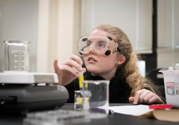 Elizabeth Burton, a junior at Simon Kenton High School (Kenton County) uses a syringe to mix chemicals while executing a through-course task in Deborah Brock's chemistry class. Through-course tasks, which make up one of three major components in Kentucky's new science assessment system, provide a way for students to demonstrate science skills. Photo by Bobby Ellis, March 29, 2018