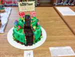 Library media specialist Alaine Carpenter gets students at Morton Middle School (Fayette County) excited about reading through an edible book contest, in which students have to create a scene from a book and at least 50 percent of the display must be edible. Eighth-grader Shelby Lynch received a first-place award this year for her entry, a cake decorated to depict a scene from Roald Dahl’s “Charlie and the Chocolate Factory.” Photo by Linda Dawahare/FCPS